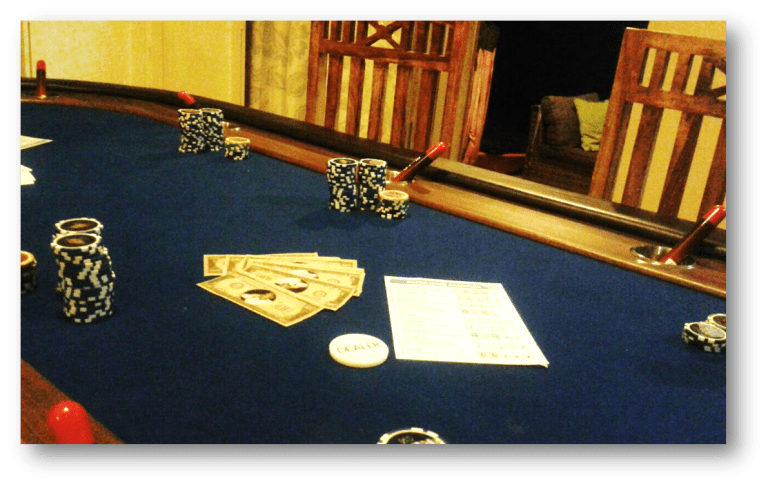 A poker table featuring various chips and bills.